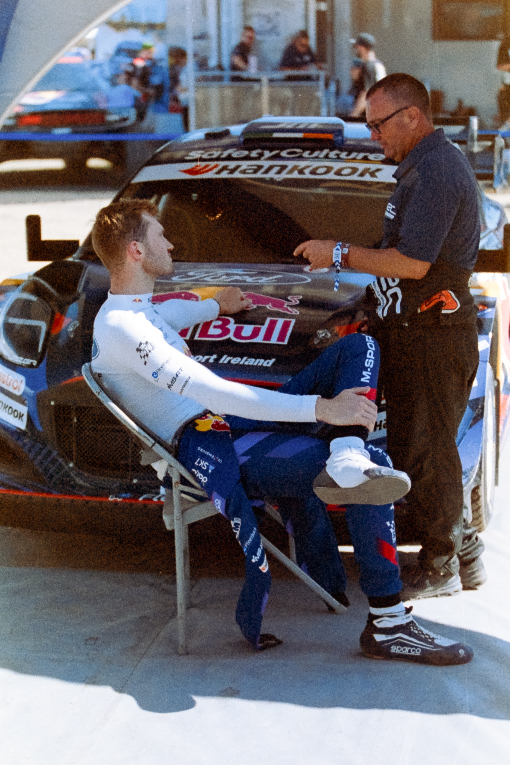 Grégoire Munster in conversation in front of his Puma Hybrid Rally1 captures a moment. 